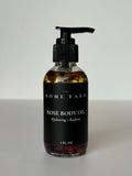 Rose Body Oil bottle displaying golden elixir with fresh rose petals