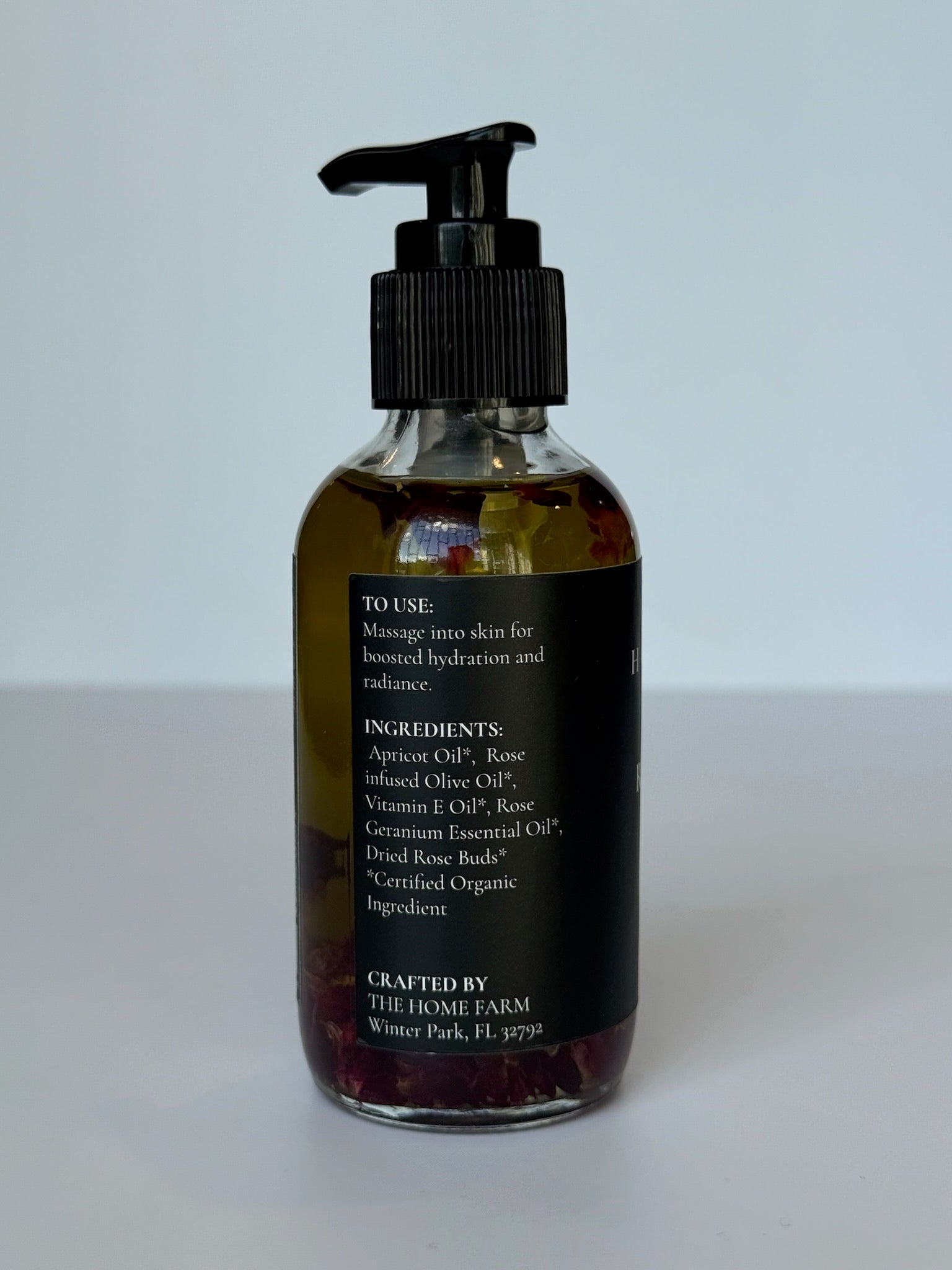 Close-up of rose body oil texture and consistency on skin